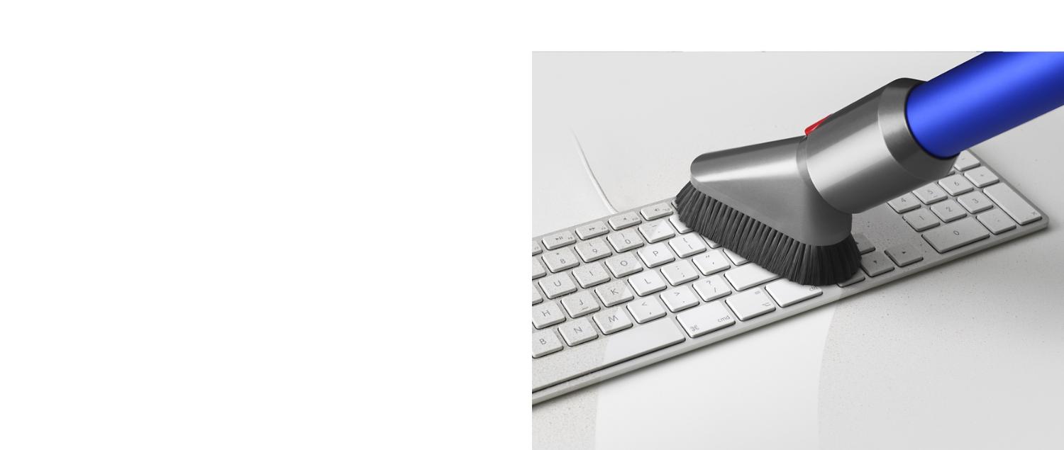 Mini soft dusting brush cleaning a keyboard